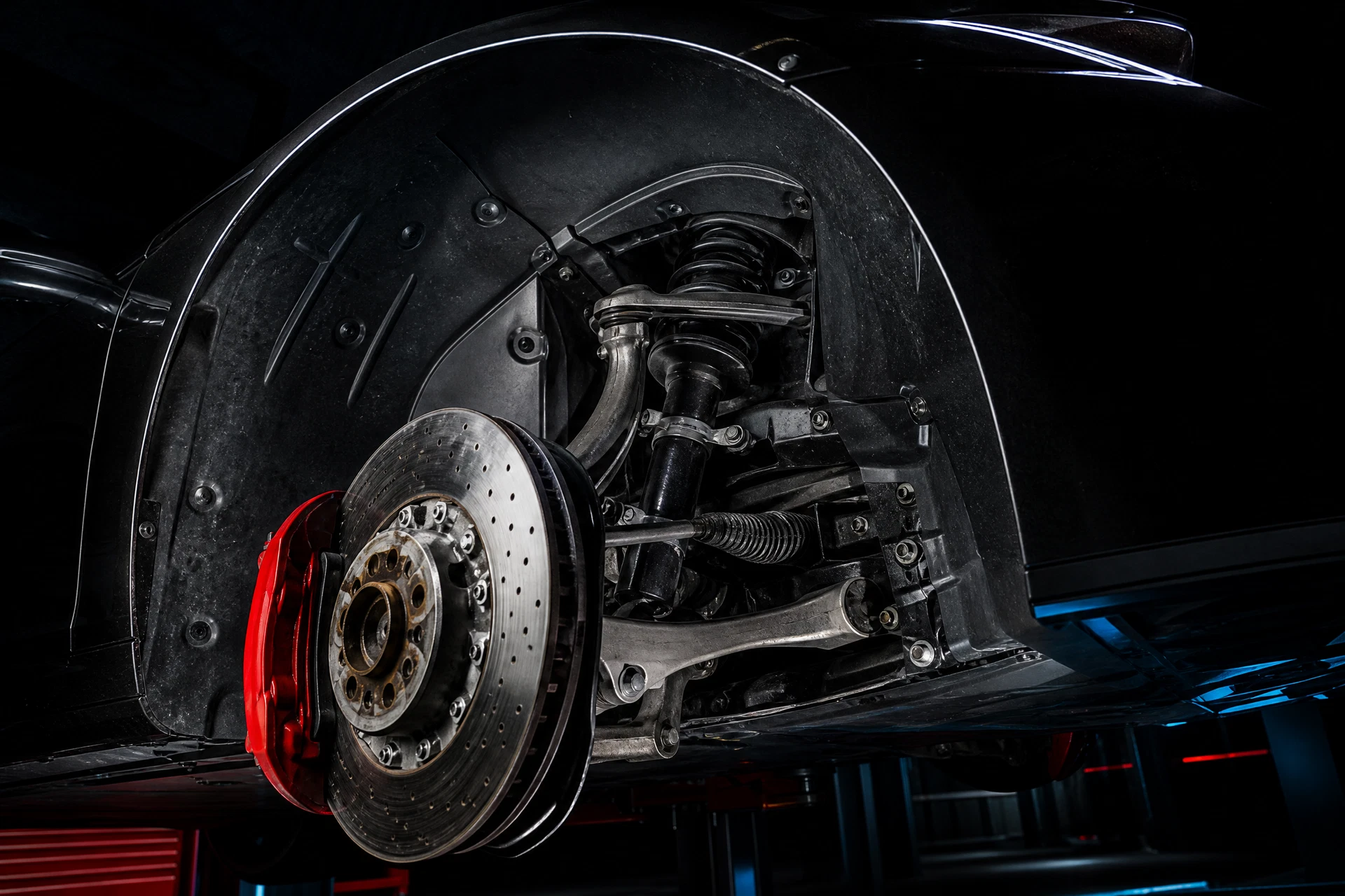 Collector-car wheel well and suspension prepared for detailed surface inspection